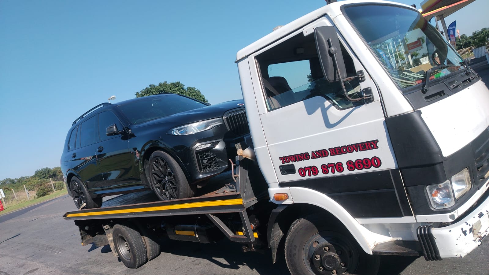 Black BMW X7 loaded on an Umhlali flatbed tow truck